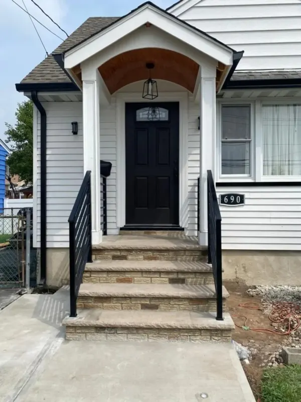 Residential front entry with steps and railing