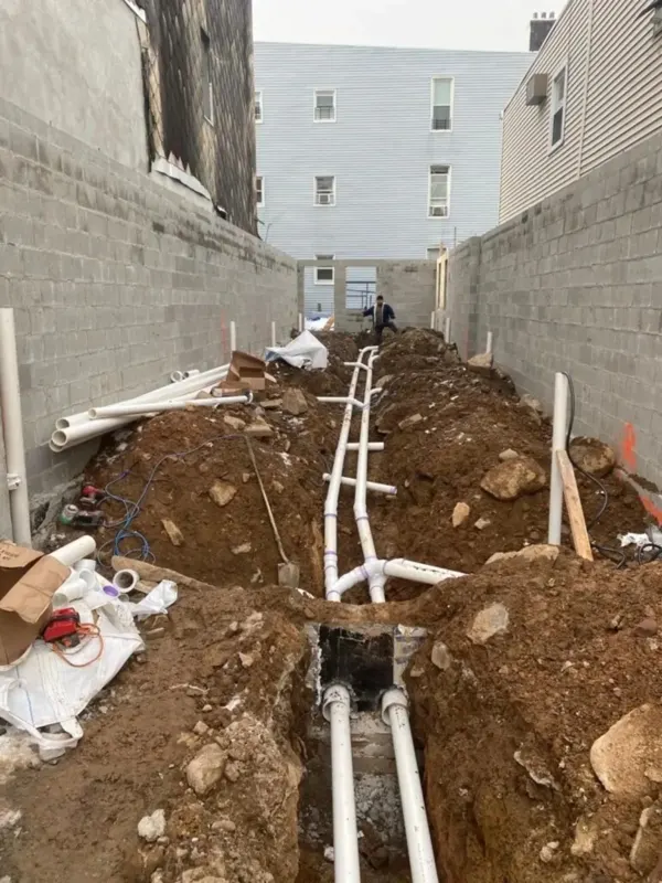 Underground plumbing installation between buildings